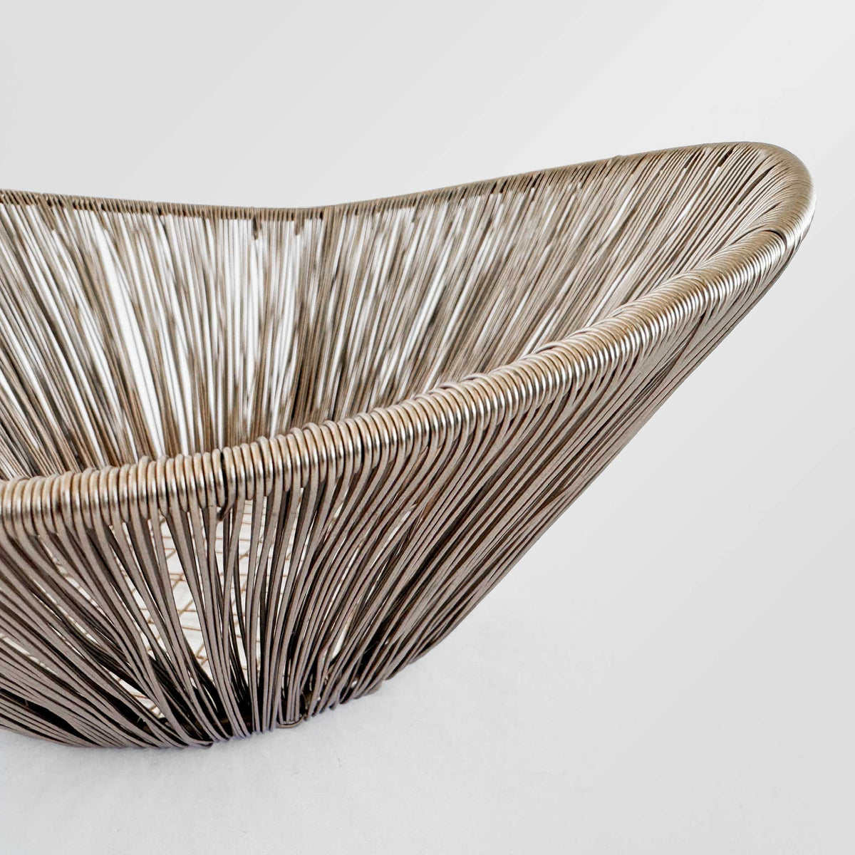 M. By Design - Curated tabletop essentials. Woven rattan basket on a light gray background