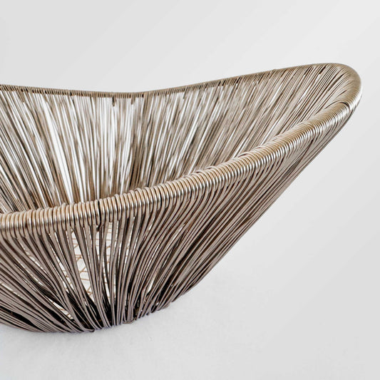 M. By Design - Curated tabletop essentials. Woven rattan basket on a light gray background