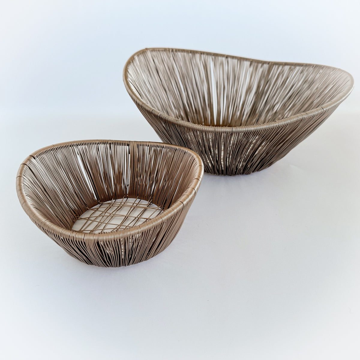 M. By Design - Curated tabletop essentials. Two woven baskets on a white background