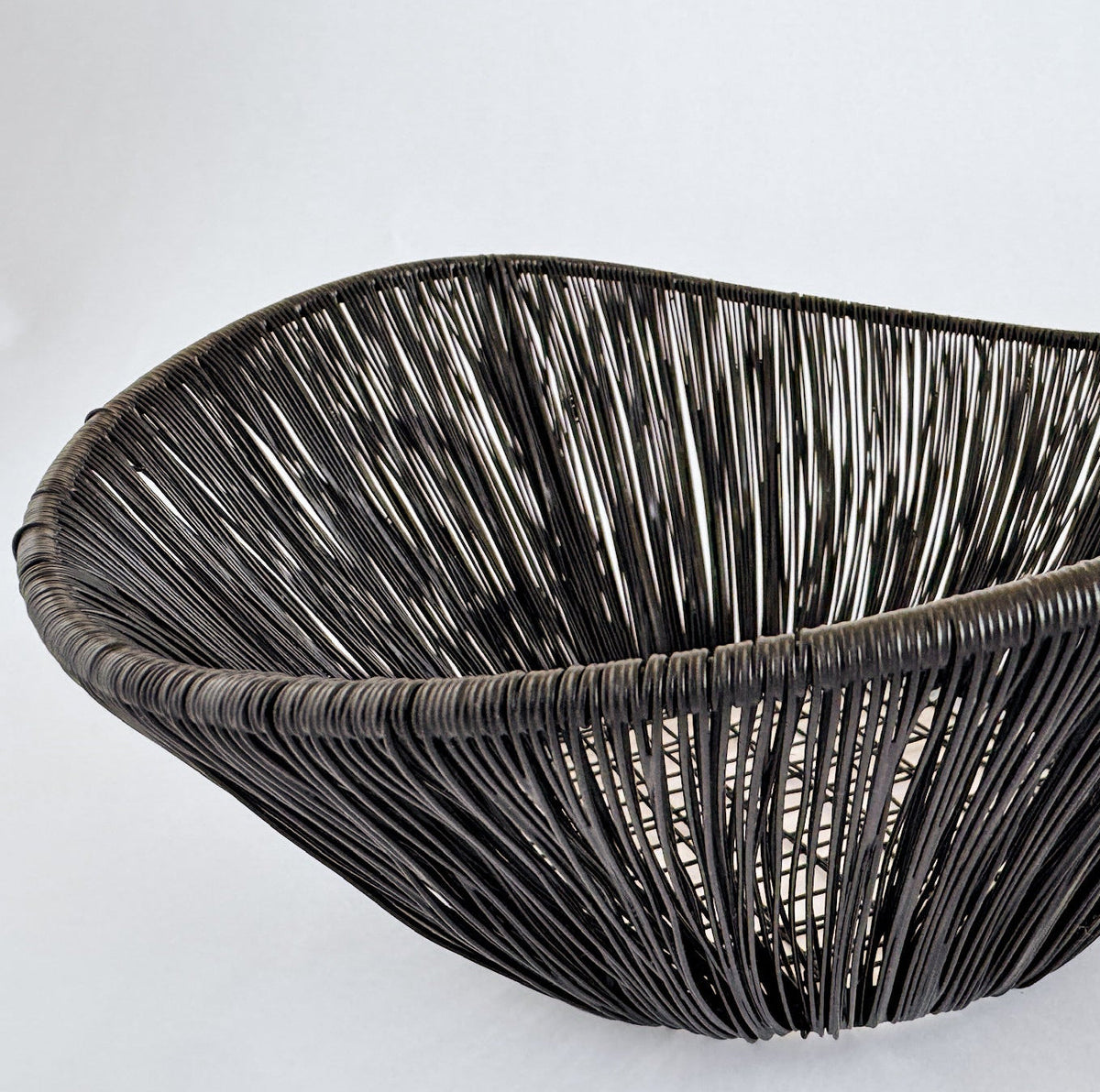 M. By Design - Curated tabletop essentials. Woven black basket on a light gray background