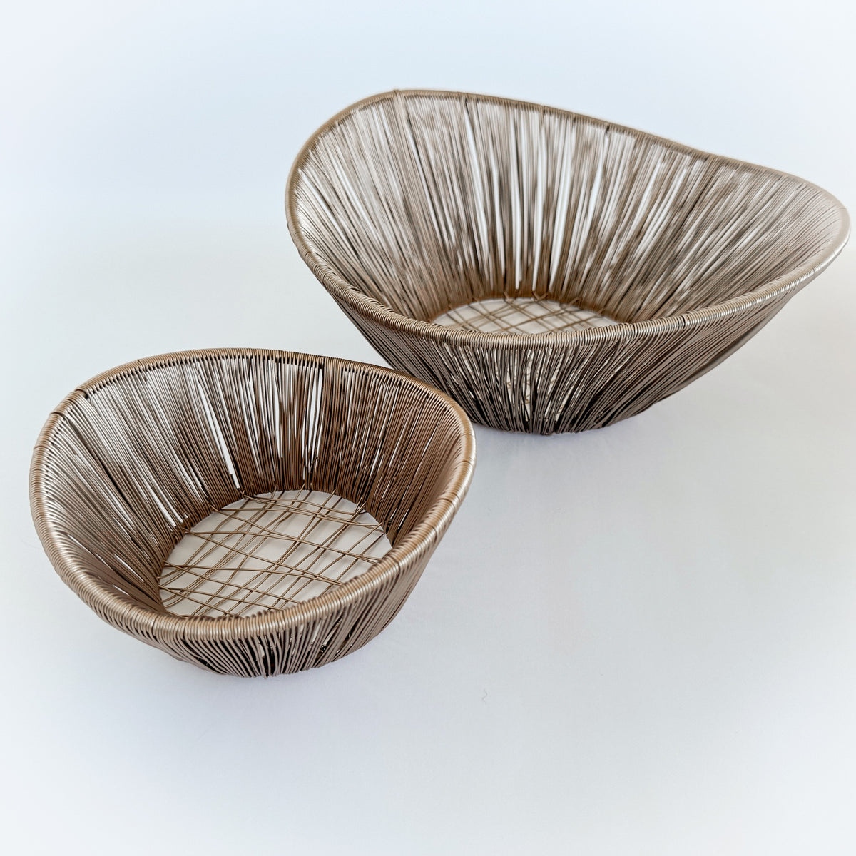 M. By Design - Curated tabletop essentials. Two woven baskets on a white background