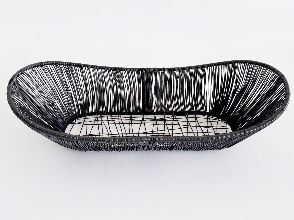 M. By Design - Curated tabletop essentials. Black woven bread basket on a white background
