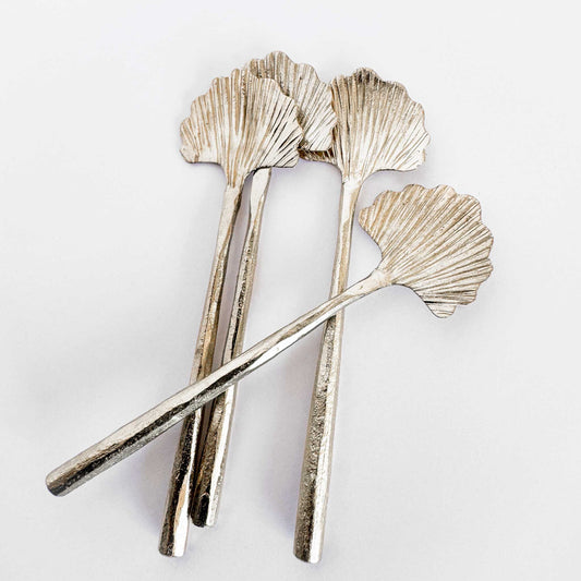 M. By Design - Curated tabletop essentials. Set of silver leaf-shaped spoons on a light gray background
