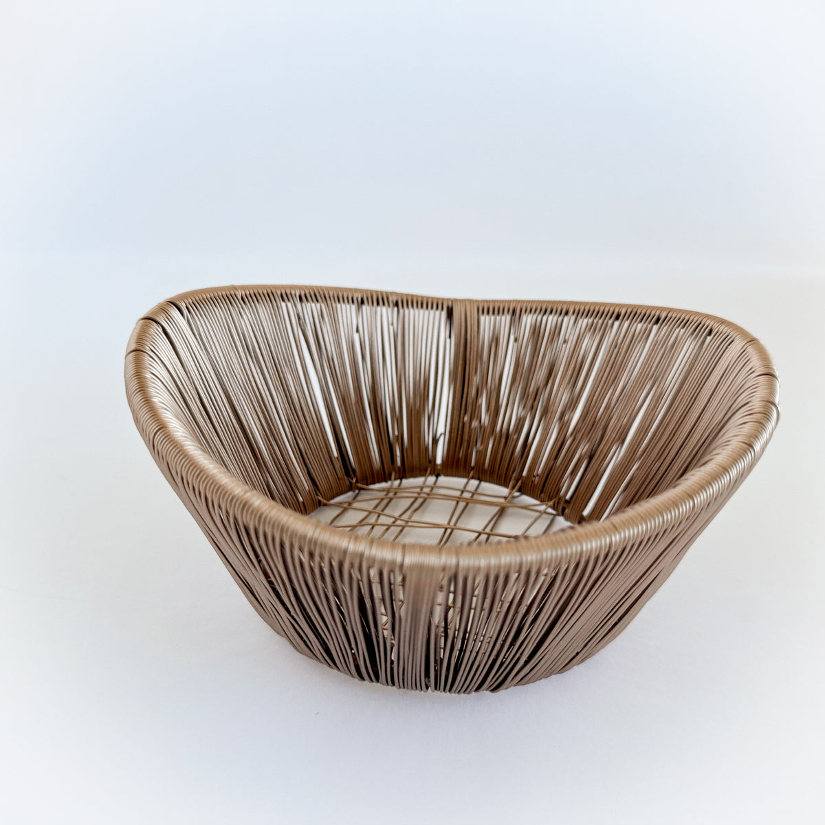 M. By Design - Curated tabletop essentials. Woven brown basket on a white background