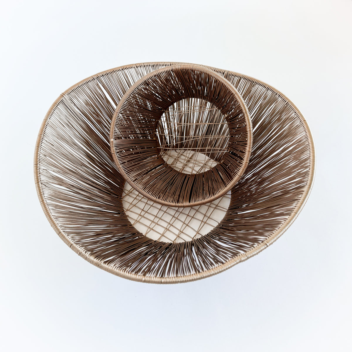 M. By Design - Curated tabletop essentials. Two woven baskets of different sizes on a light gray background